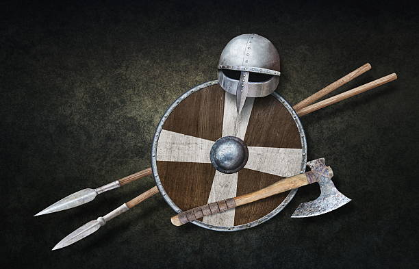 viking's helmet axe wooden shield and two spears on dark grunge background