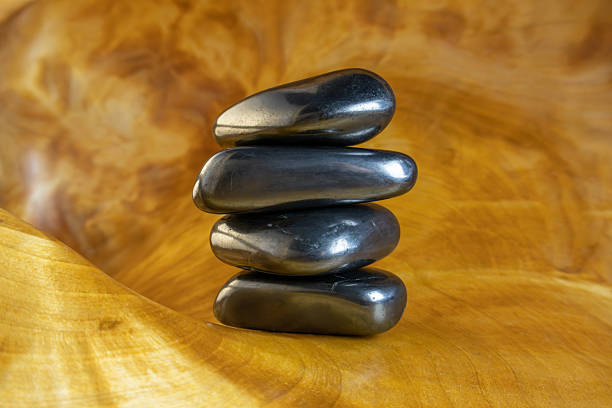 Shungite stones on wooden background