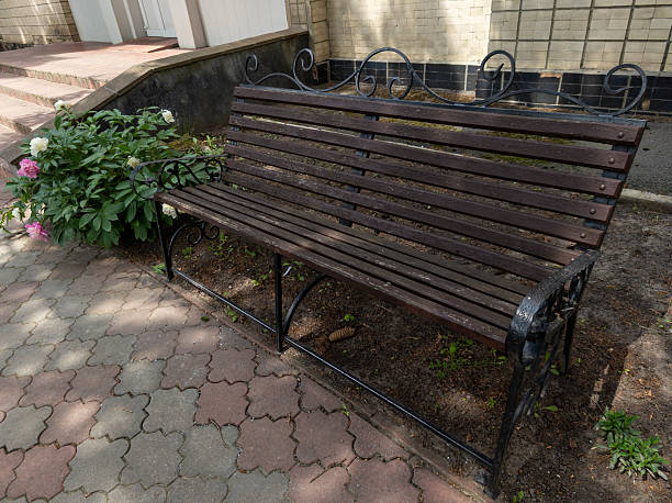 istock A wooden bench sitting in front of a brick building 2219637182
