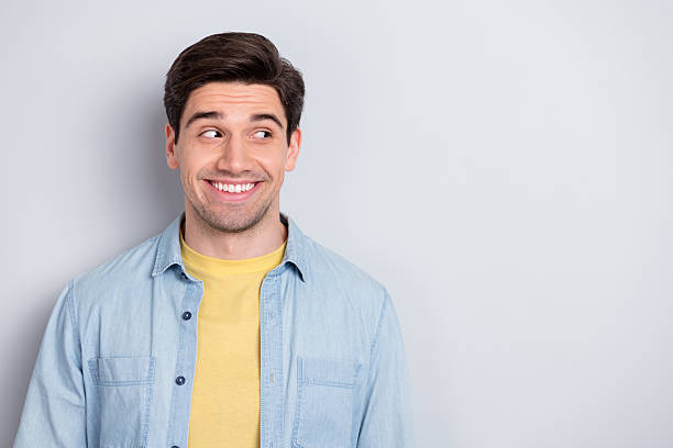 istock Photo of confident attractive young guy dressed denim shirt looking empty space isolated grey color background 2219637425