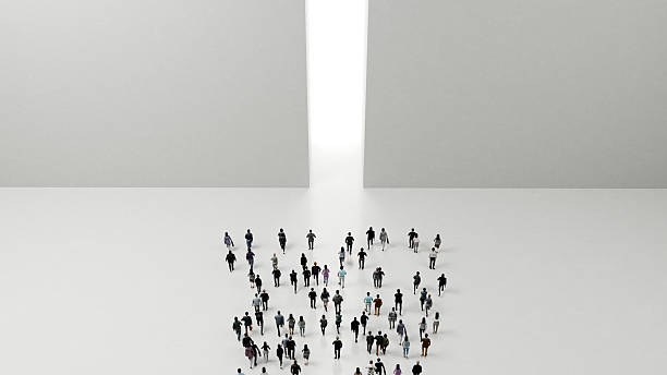 istock Large group of people running towards a bright light between two walls 2219638356