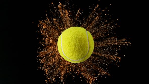istock Tennis ball with coloured powder explosion. 2219639661