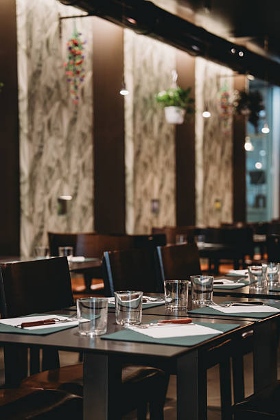 istock Elegant restaurant tables awaiting customers, showcasing modern interior design 2219639921