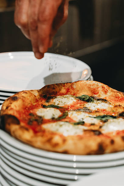 istock Chef sprinkling spices on a delicious Neapolitan pizza 2219639987