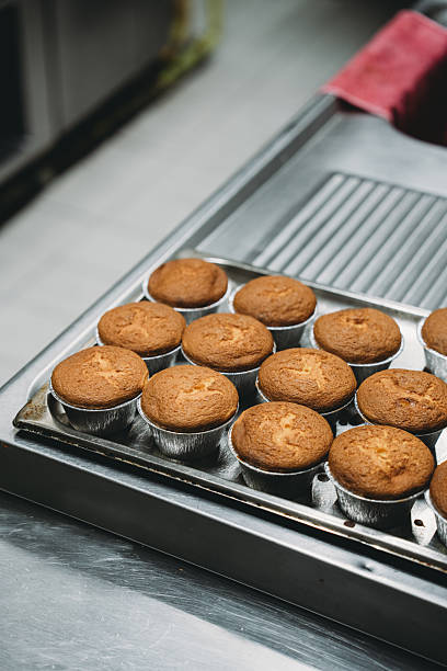 Freshly baked muffins cooling on a metal tray