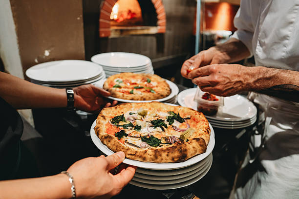 istock Chef preparing gourmet pizza in restaurant kitchen 2219640021