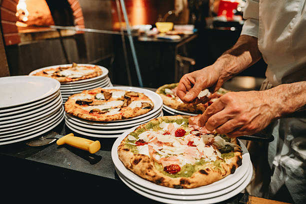 Chef preparing gourmet pizzas in a restaurant kitchen
