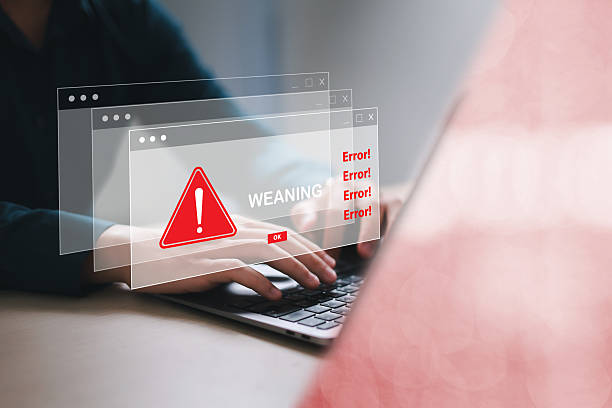 istock Businessman using laptop with spam virus with warning for internet security alert and data breach or hacker or spyware attack. 2219642328