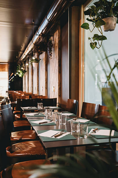 istock Elegant restaurant interior design with set tables awaiting customers 2219644184