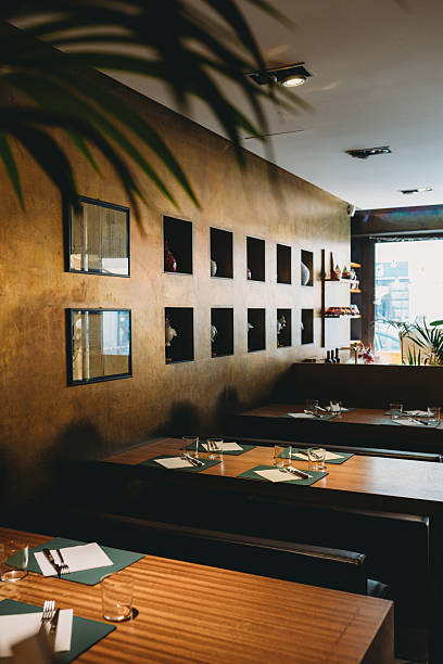 istock Elegant restaurant interior with wooden tables and decorative wall 2219644185