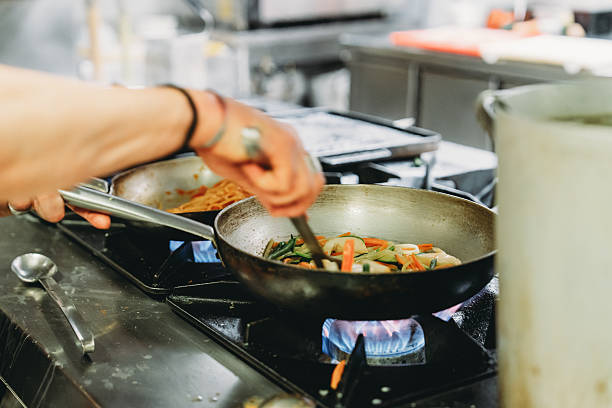 istock Chef preparing delicious meal with fresh vegetables in professional kitchen 2219644186