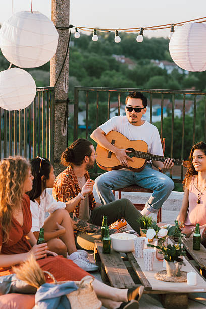 istock The hippies having summer rooftop party. 2219644343