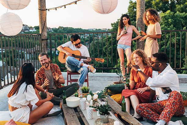 istock Multiracial friends are having rooftop party. 2219644681