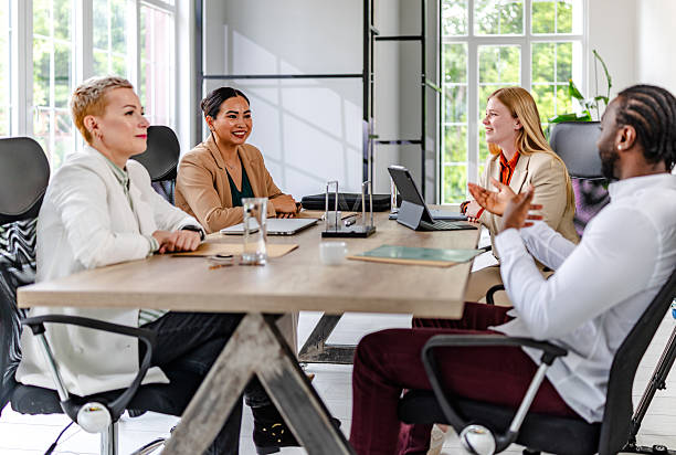 istock Young black man leads a diverse team meeting in a modern office setting focused on collaboration and success 2219644991