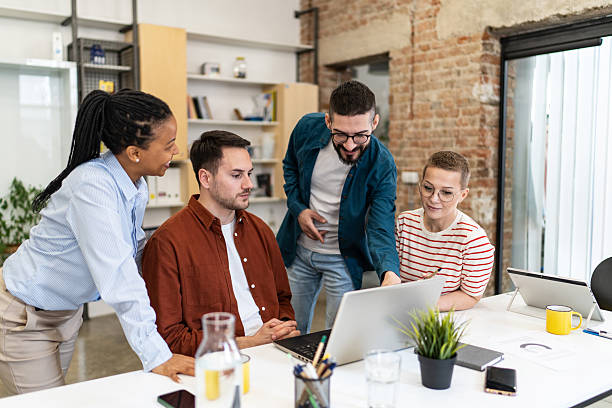 istock Diverse business team collaborating on a project using laptop in office 2219645242