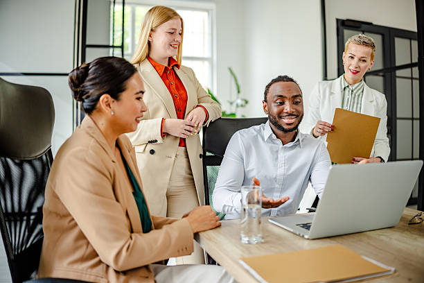 istock Young black man leads a dynamic team meeting in a modern office environment focused on collaboration and innovation 2219645253