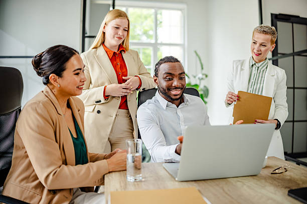istock Young black man leading a dynamic team discussion in a modern office setting, showcasing collaboration and engagement 2219645318
