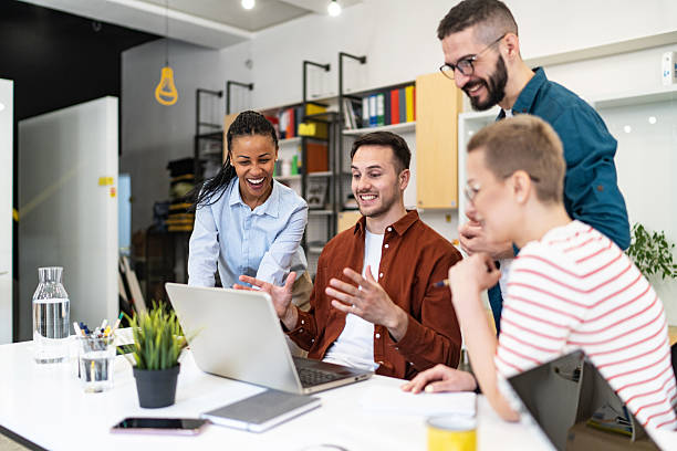 istock Young professionals collaborating on laptop in modern office 2219645914