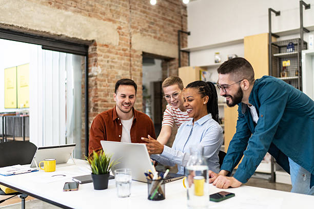 istock Young professionals collaborating on a project using laptop in modern office 2219646067