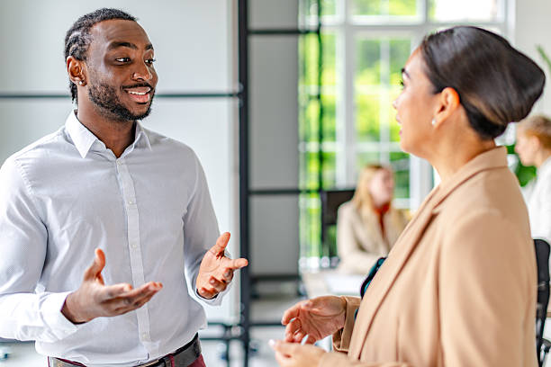 istock Young black man leads a business discussion in a modern office environment with confidence and professionalism 2219646284