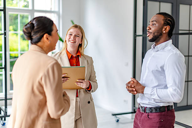 istock Young black man leads a business discussion with colleagues in a modern office setting during a daytime meeting 2219646461