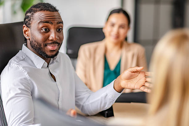 istock Young black man leads a dynamic business meeting in a modern office setting 2219646773