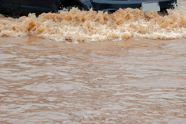 Heavy rain causes urban flooding as water covers streets, disrupting daily life and transportation.