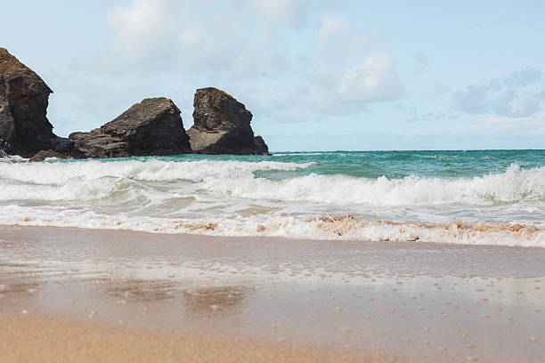 Rock formations and ocean waves at Porthcothan Bay shoreline, Cornwall, landscape seascape