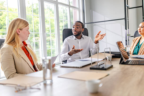 istock Young black entrepreneur leads a dynamic business meeting in a modern office environment 2219647944