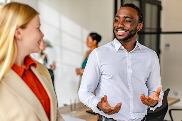istock Confident young black man leading a team discussion in a modern corporate office setting 2219649119