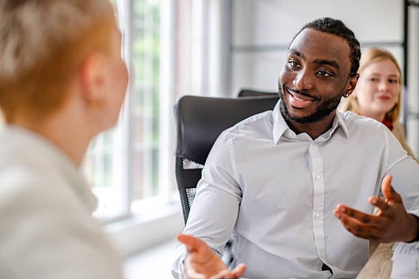 istock Young black entrepreneur demonstrates effective leadership in modern corporate setting during a team meeting 2219649742