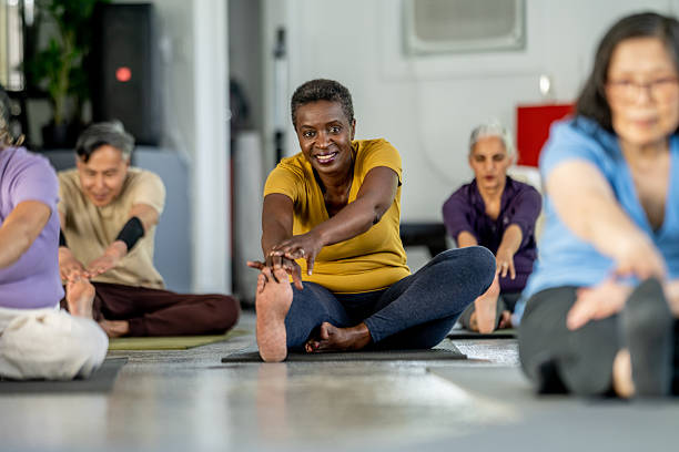 istock Senior Group Practicing Yoga Together in a Peaceful Indoor Setting 2219651083