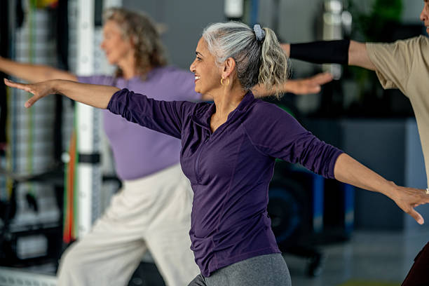 istock Group of Senior Adults Practicing Yoga in a Studio Setting 2219651161