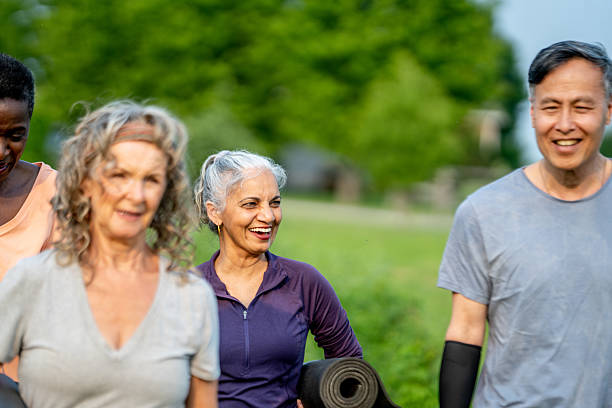 istock Group of Seniors Smiling and Exercising Outdoors in a Park Setting 2219651187