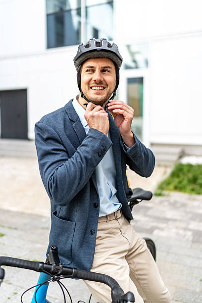 istock Businessman wearing helmet while sitting on bicycle 2219652187