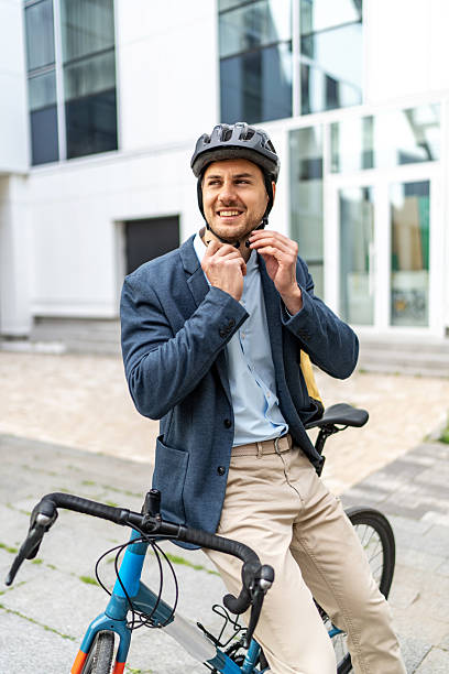 istock Businessman wearing helmet while sitting on bicycle 2219652189