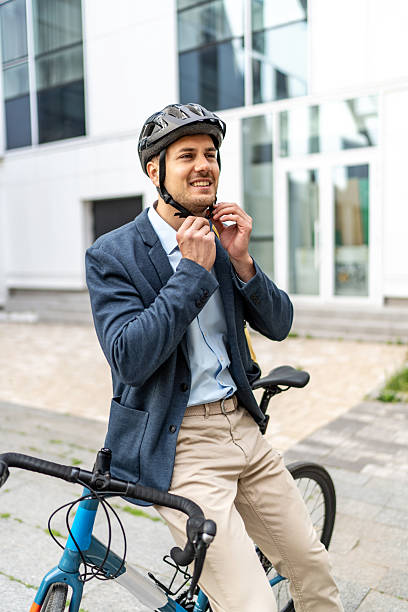 istock Businessman wearing helmet while sitting on bicycle 2219652250