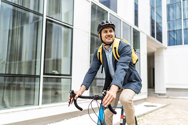 istock Businessman riding bicycle to work in urban setting 2219652322