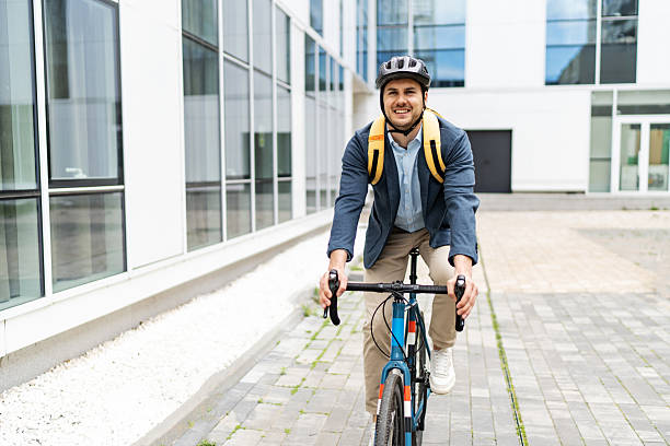 istock Businessman riding bicycle to work in urban setting 2219652328