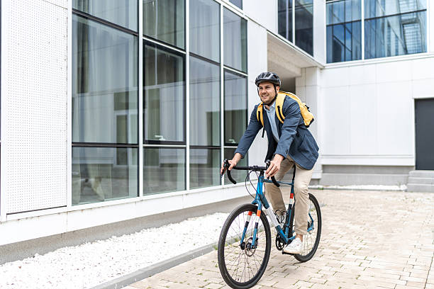 istock Businessman riding bicycle to work in urban setting 2219652332