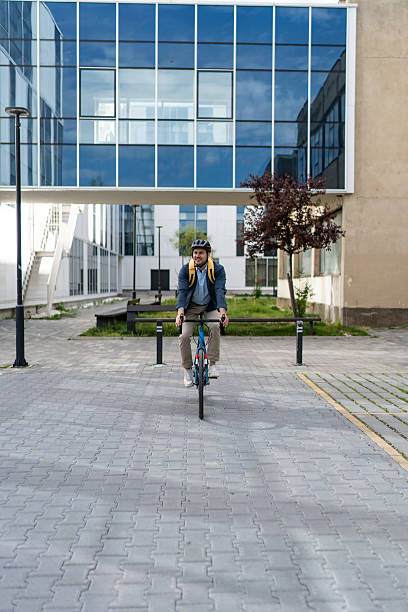 istock Businessman riding bicycle in urban environment 2219652417