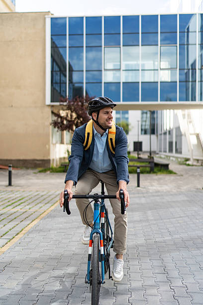 istock Businessman riding bicycle to work in urban setting 2219652419
