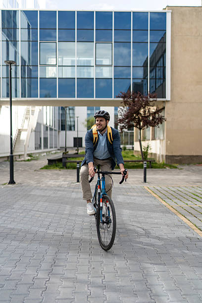 istock Businessman riding bicycle to work in urban setting 2219652428