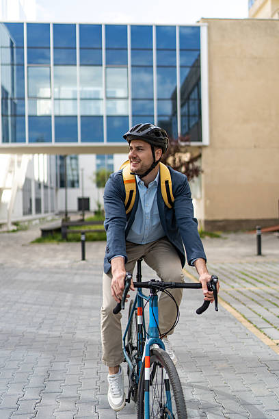istock Businessman riding bicycle to work in urban setting 2219652434
