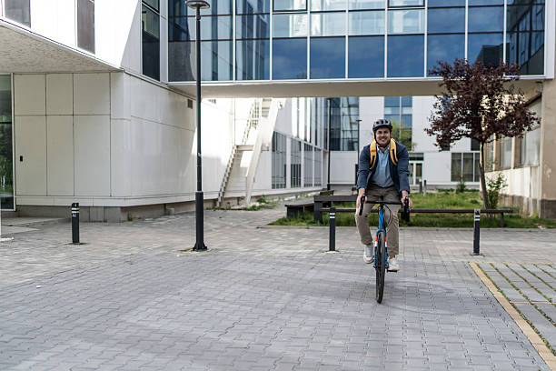istock Businessman riding bicycle in urban environment after work 2219652436