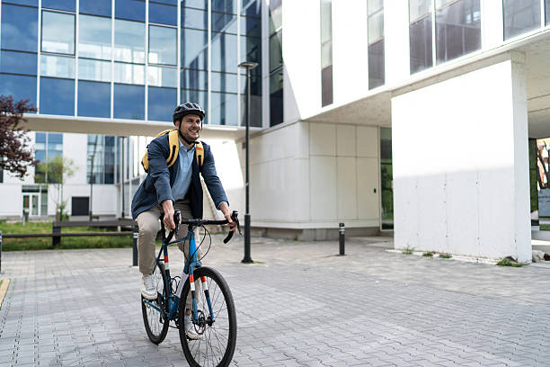 istock Businessman riding bicycle to work in urban setting 2219652458