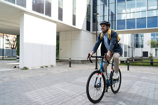 istock Businessman riding bicycle to work in urban setting 2219652460