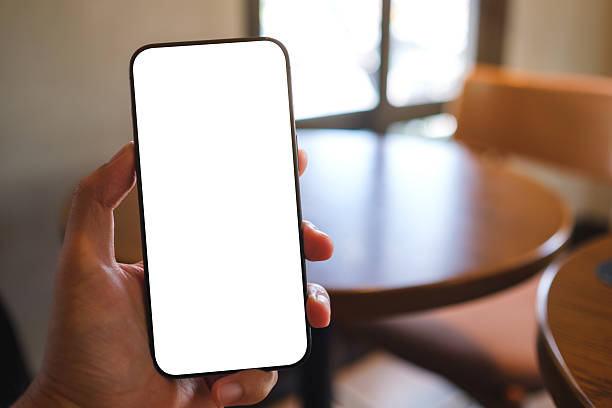 istock Mockup image of a man holding mobile phone with blank white screen in cafe 2219652863