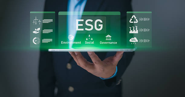 istock Hand holding tablet displaying holographic ESG interface with Environment, Social, Governance icons. Symbolizes sustainable business, corporate responsibility, ethical investment for future impact now 2219653026