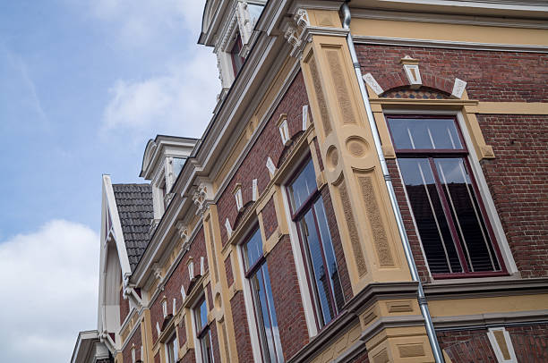 istock Elegant dutch building standing tall against a cloudy sky 2219653685